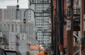 Menggali Aspirasi Masyarakat Humbang Hasundutan untuk Indonesia dan Dunia man in orange jacket walking on street during daytime